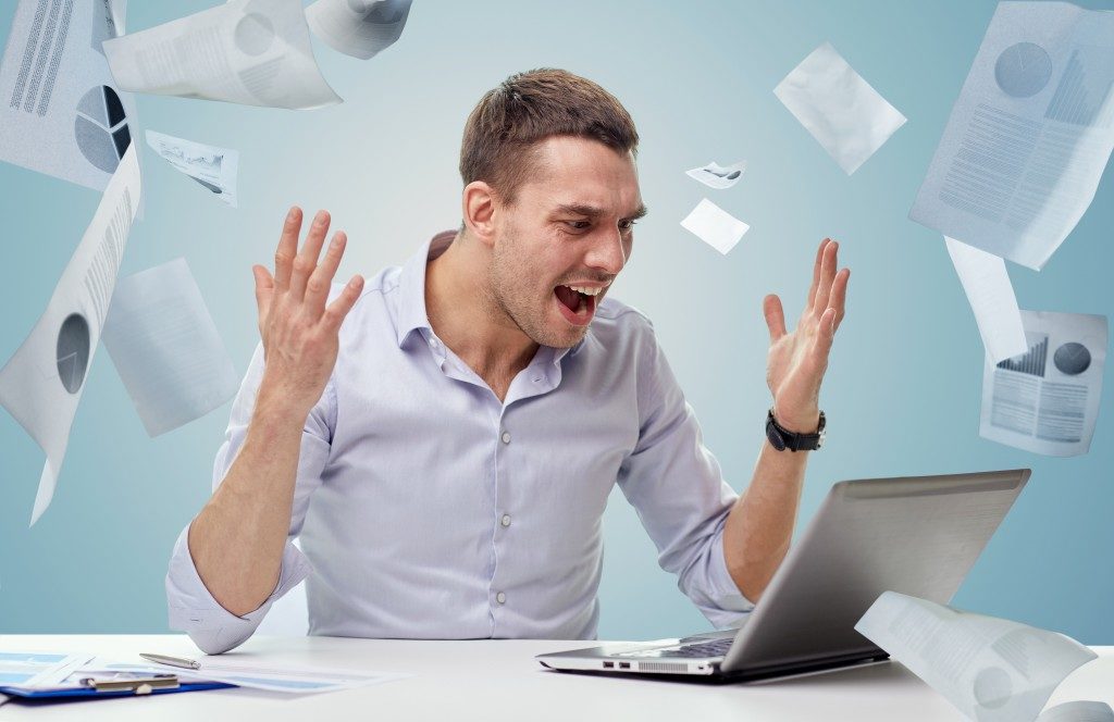stress and frustration at work, throwing papers