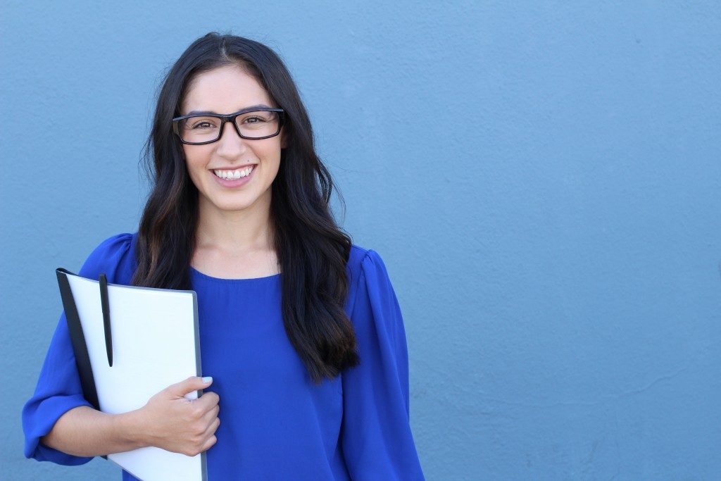 woman carrying books