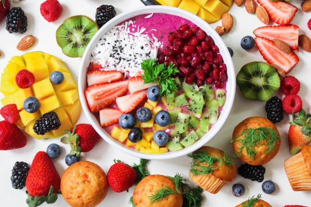 freshly cut fruits and vegetables with milk on a container