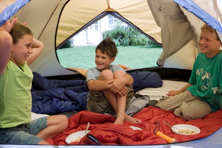 kids inside a tent having a sleepover