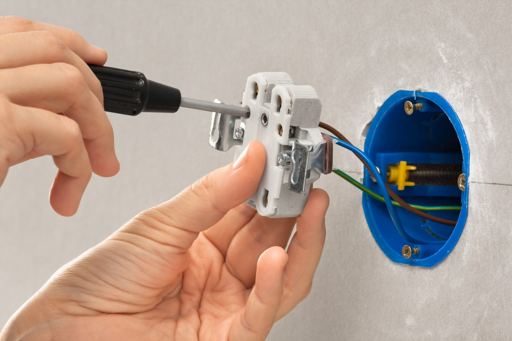 Installation of an electrical plug to a wall