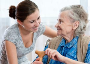 A woman talking to an elderly lady at home