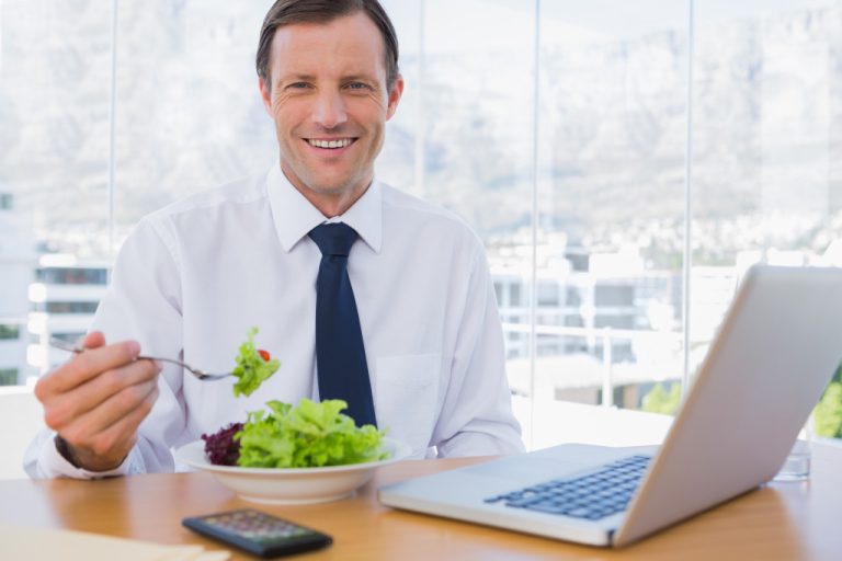 an employee eating a salad while at work