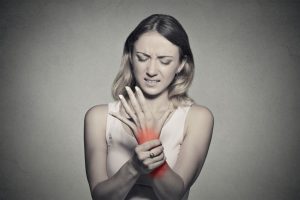woman with wrist pain in red